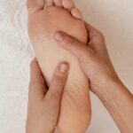 close up hands massage foot
