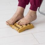woman using feet massage device